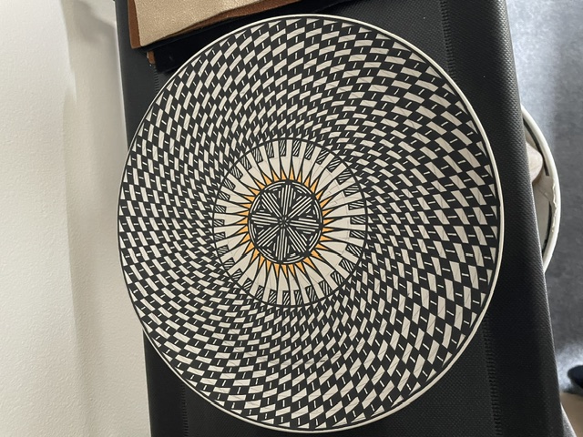 Black and white radial platter with an orange sun center